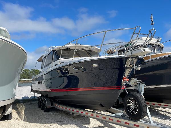 Cutwater 30 Sedan LE 2016 Cutwater 30 Sedan LE boat on trailer under blue sky.
