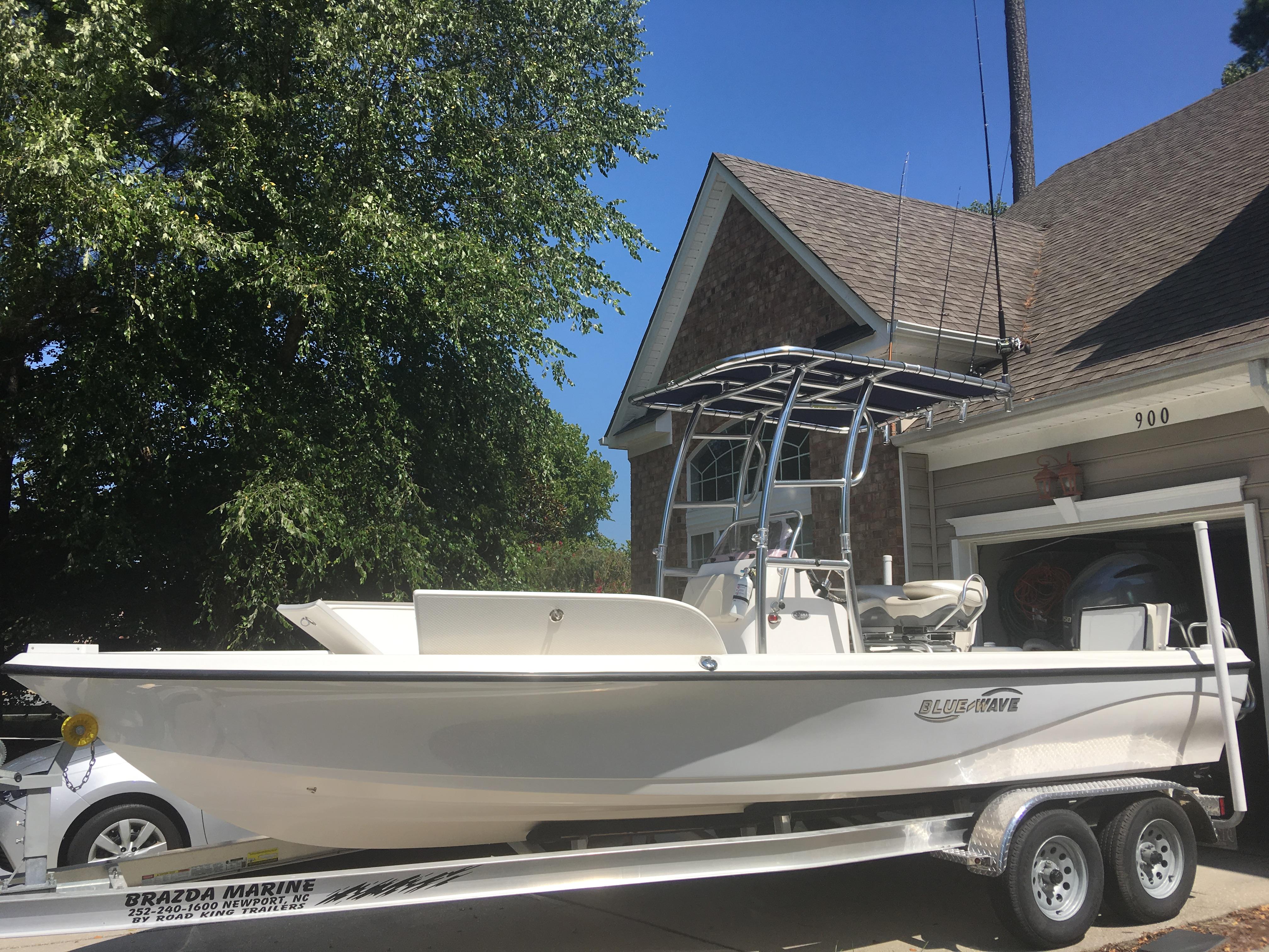 Blue Wave 2200 SL 2018 Blue Wave 2200 SL boat on trailer, parked in driveway, sunny day.