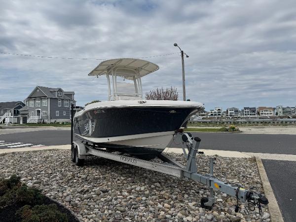 Robalo R200 Center Console 2018 Robalo R200 Center Console boat on trailer, parked near waterfront homes.