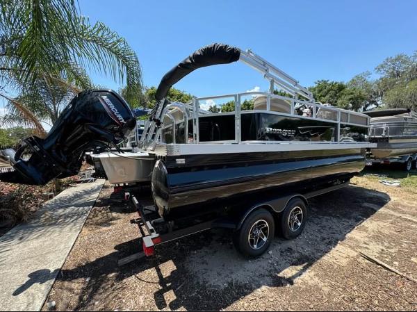 Ranger Reata 200C 2024 Ranger Reata 200C pontoon boat on trailer, parked outdoors.