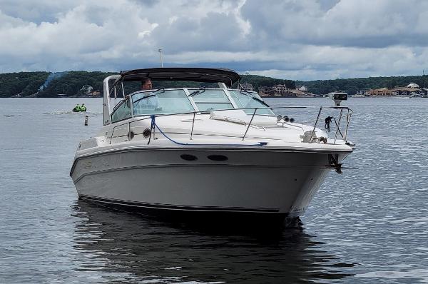 Sea Ray 330 Express Cruiser 1994 Sea Ray 330 Express Cruiser on calm water under cloudy skies.