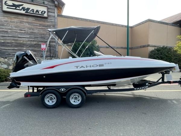 Tahoe 2150 2024 Tahoe 2150 boat on trailer, parked outside a building.