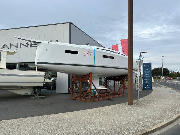 Jeanneau Sun Odyssey 380 2025 Jeanneau Sun Odyssey 380 sailboat displayed on a stand outside a showroom.