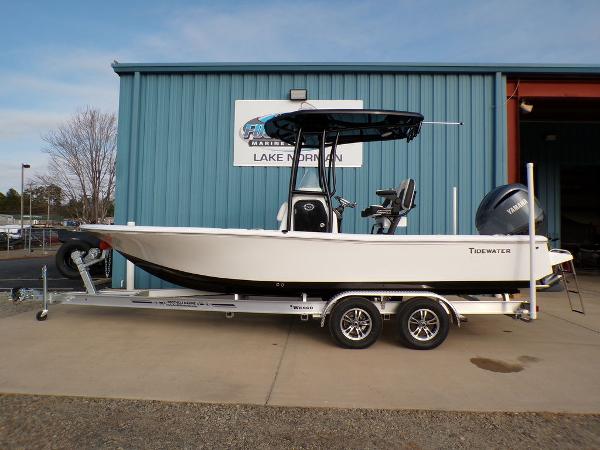 Tidewater 2210 Cb 2025 Tidewater 2210 Cb boat on trailer, parked outside a blue building.