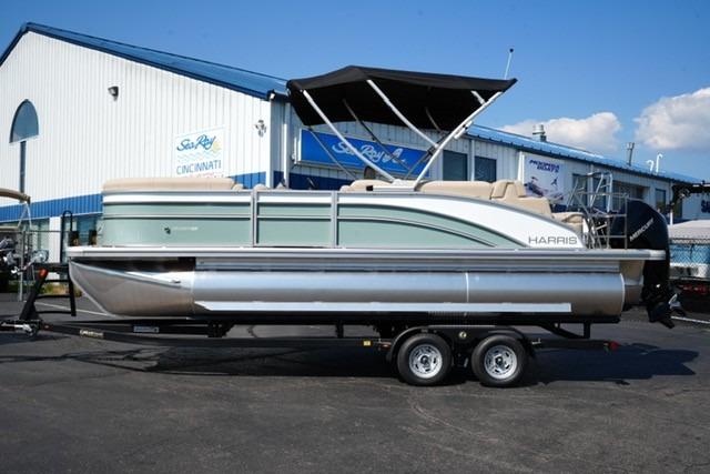Harris Cruiser 210 2026 Harris Cruiser 210 pontoon boat on trailer, parked outside a marine dealership.