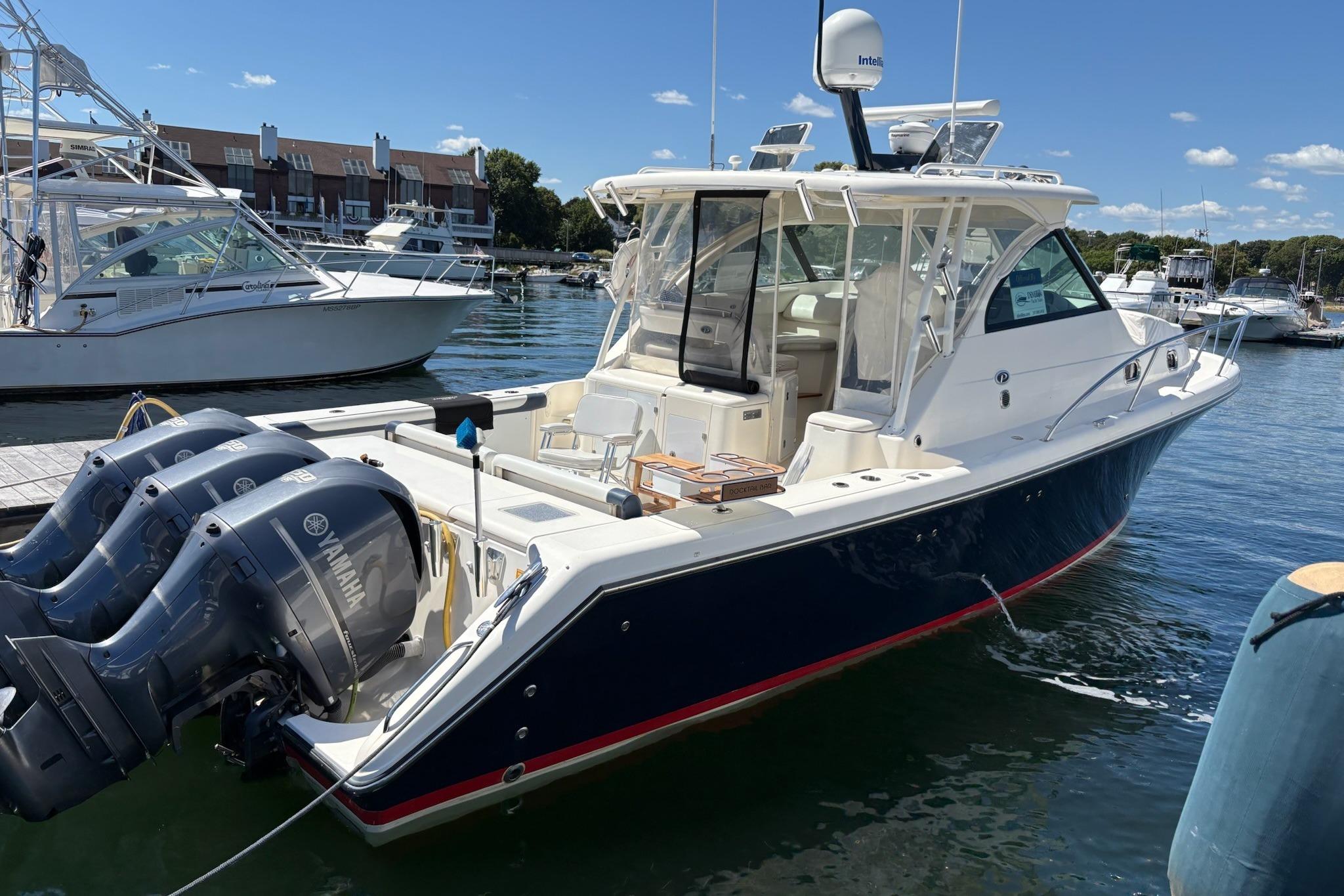 Pursuit OS 375 Offshore 2009 Pursuit OS 375 Offshore boat docked with triple Yamaha engines.