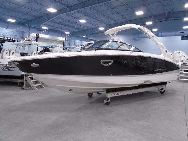 Regal LX6 2025 Regal LX6 boat in showroom, sleek design, black and white exterior.