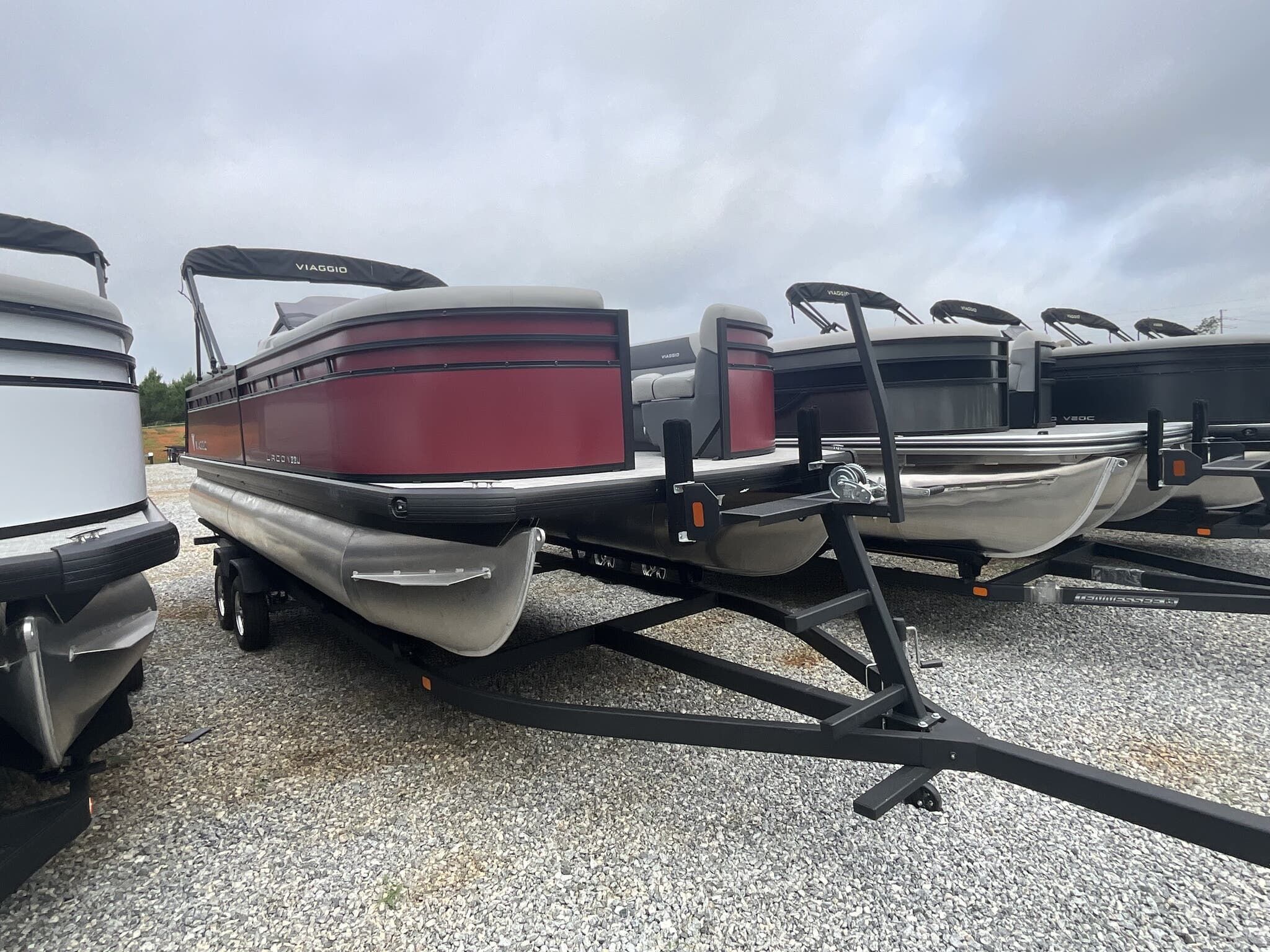 Viaggio Lago V 22U 2025 Viaggio Lago V 22U pontoon boat on trailer, parked on gravel lot.