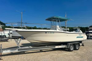 Pursuit 2470 Center Console 1995 Pursuit 2470 Center Console boat on trailer, clear sky background.