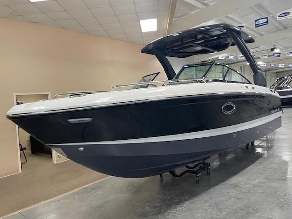 Chaparral 267 SSX 2025 Chaparral 267 SSX boat in showroom, sleek black and white design.