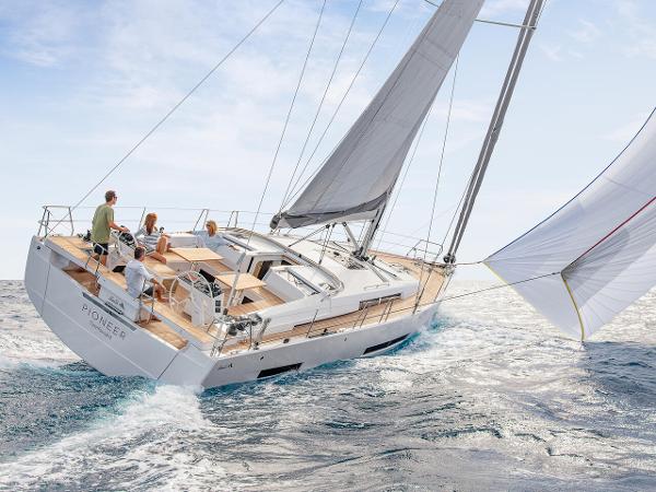 Hanse 510 2025 Hanse 510 yacht sailing on open sea with passengers enjoying the deck.