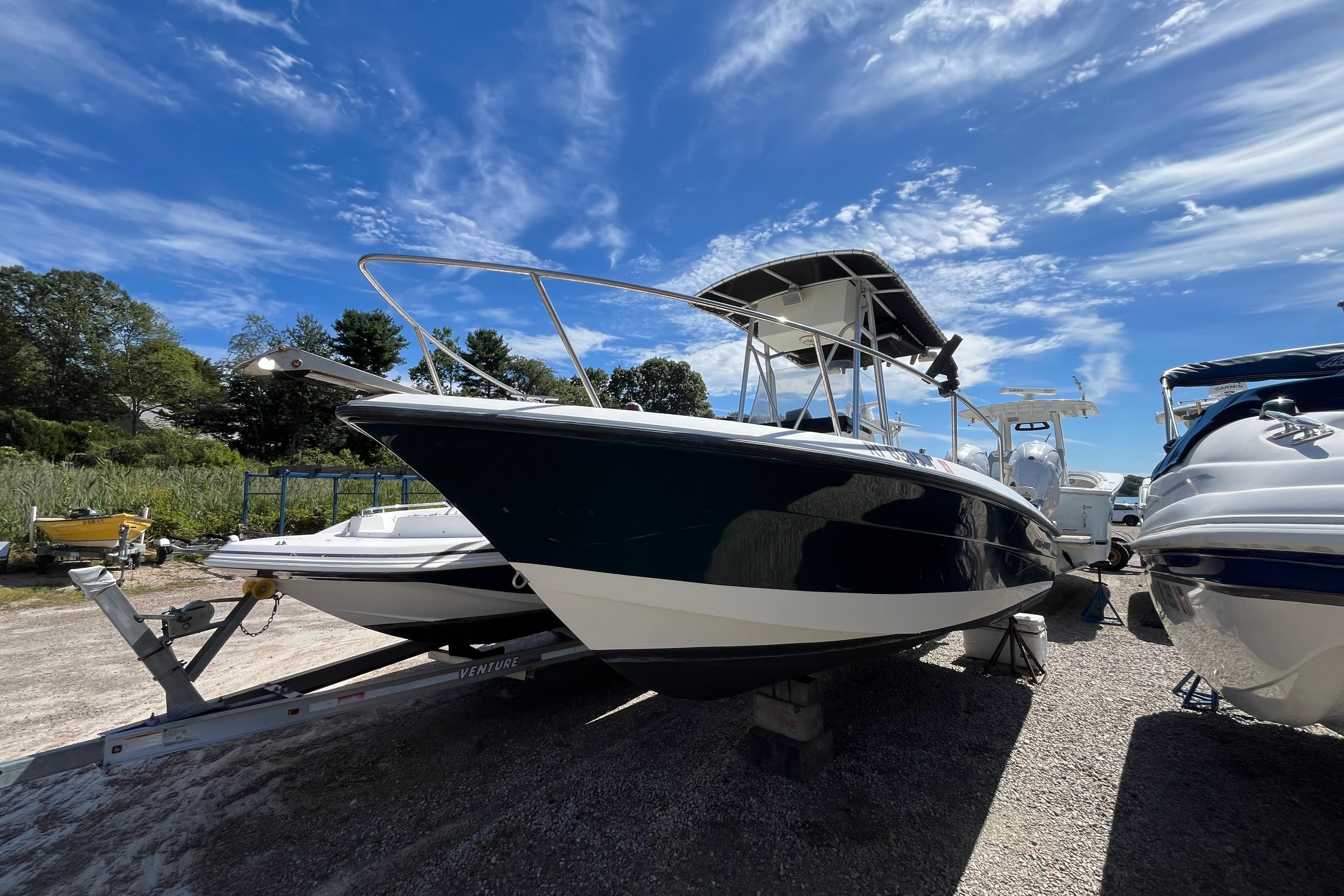 Hydra-Sports Lightning 212 CC 2005 Hydra-Sports Lightning 212 CC boat on trailer under clear blue sky.
