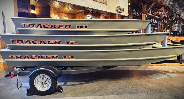 Tracker Grizzly 1036 Utility 2025 Tracker Grizzly 1036 Utility boats stacked on trailer in showroom.