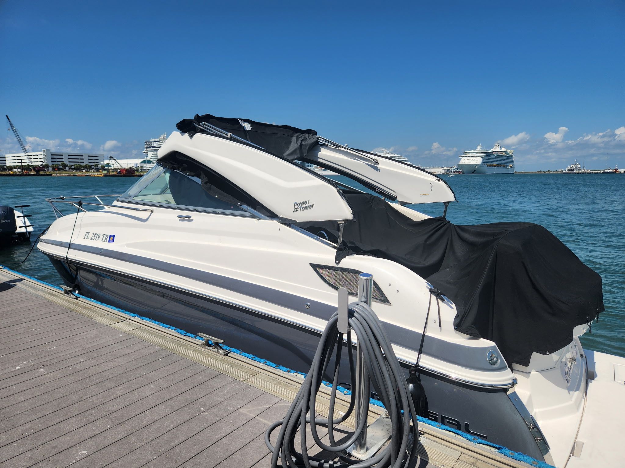 Regal 28 Express 2023 Regal 28 Express boat docked at marina under clear blue sky.
