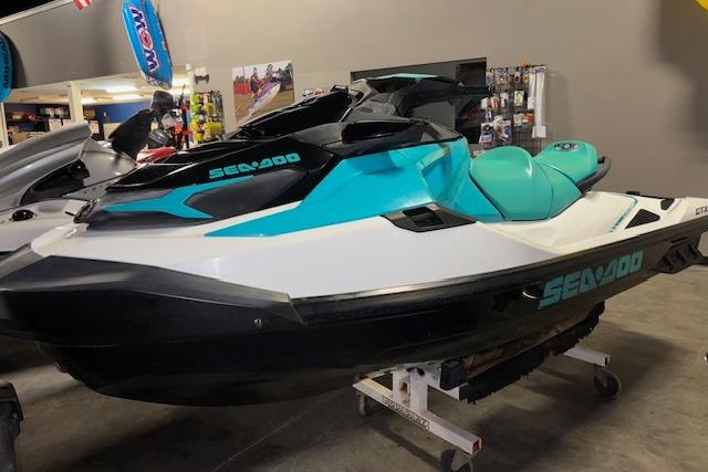 Sea-Doo GTX 2021 Sea-Doo GTX jet ski in showroom, featuring sleek turquoise and black design.