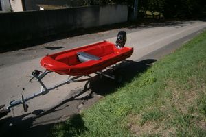 Fun Yak Secu 12 Red Fun Yak Secu 12 boat on trailer, parked on roadside, 2025 model.