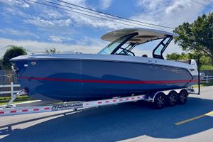 Monterey Elite 30 OB 2026 Monterey Elite 30 OB boat on trailer, blue hull, sunny day.