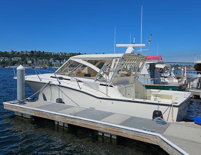 Carolina Classic Express 35 2001 Carolina Classic Express 35 boat docked at marina under clear blue sky.