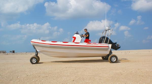 Ocean Craft Marine 7.1 M Amphibious 2022 Ocean Craft Marine 7.1 M Amphibious boat on land with wheels, clear sky background.