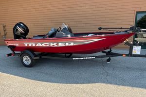 Tracker Super Guide V-16 SC Red 2026 Tracker Super Guide V-16 SC boat on trailer, parked outdoors.