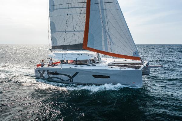 Excess 14 2024 Excess 14 catamaran sailing on open sea with full sails.