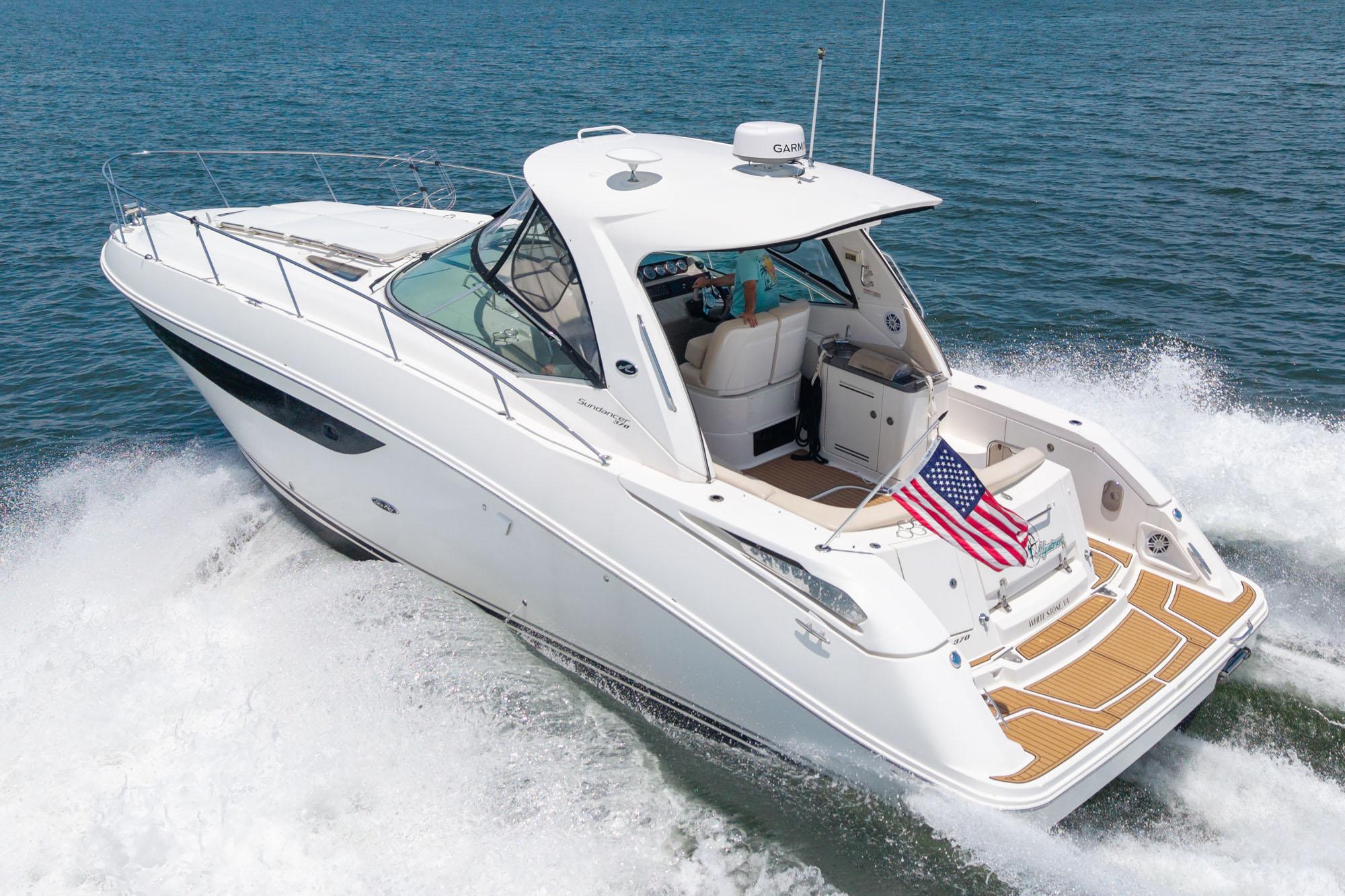 Sea Ray 370 Sundancer 2013 Sea Ray 370 Sundancer cruising on open water with American flag displayed.