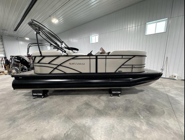 Sylvan Mirage 820 LZ w/ Change Room 2024 Sylvan Mirage 820 LZ pontoon boat in a spacious indoor setting.
