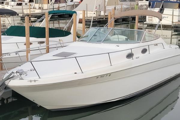Sea Ray 270 Sundancer 1999 Sea Ray 270 Sundancer boat docked in marina, white exterior, sleek design.