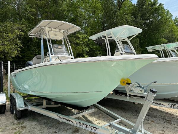 Key West 203 FS 2024 Key West 203 FS boat on trailer, parked outdoors, surrounded by trees.