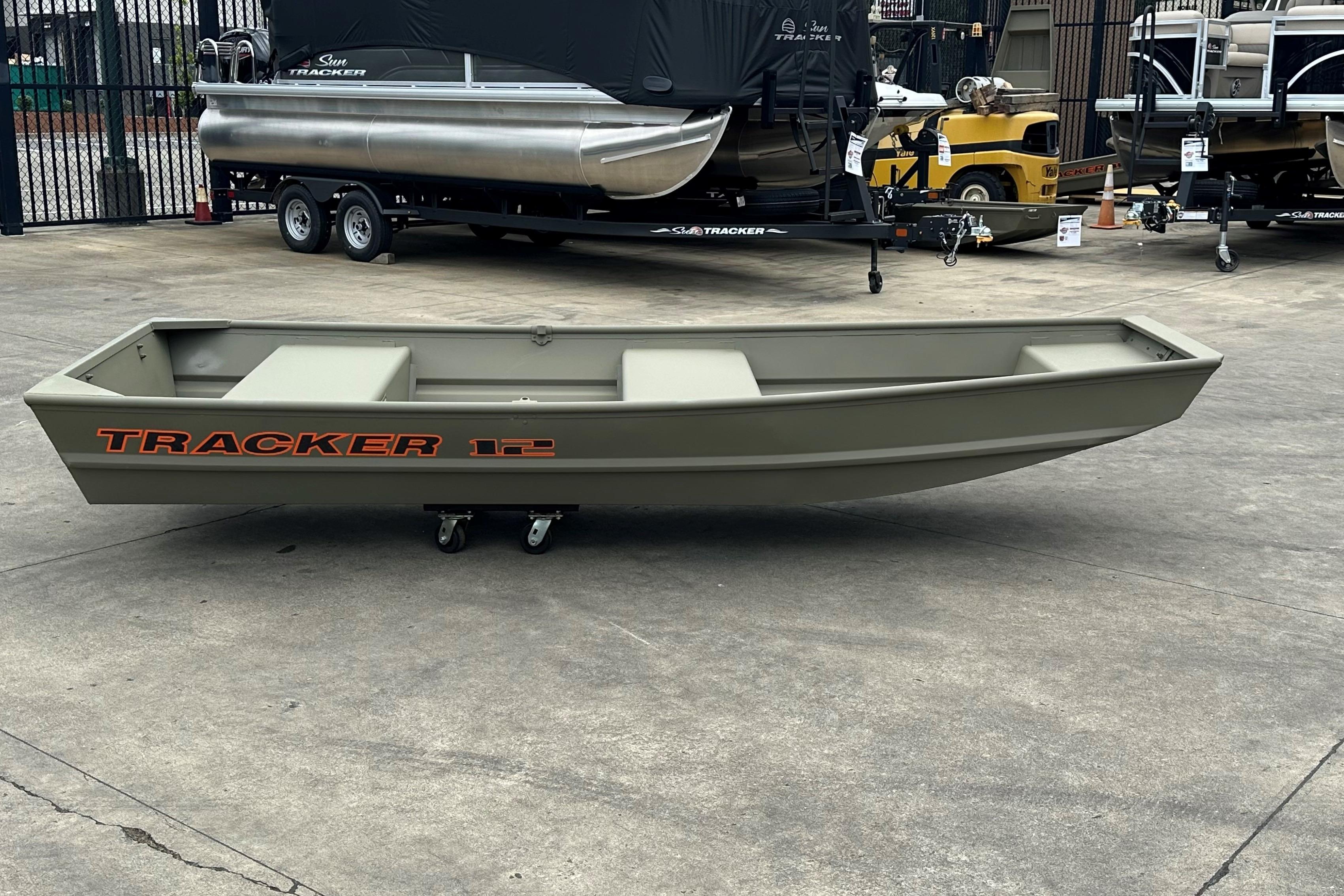 Tracker Grizzly 12 Jon 2026 Tracker Grizzly 12 Jon boat displayed on concrete lot with trailers in background.
