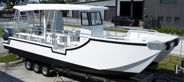 Custom 34 Custom 34 model boat, 2025, on trailer, white and black design, docked outdoors.