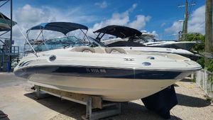 Sea Ray 270 Sundeck 2004 Sea Ray 270 Sundeck boat on a trailer under a clear blue sky.