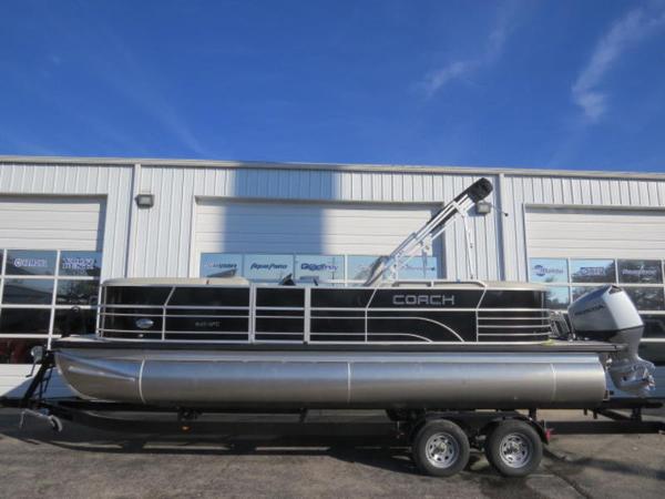 Coach Pontoons 243 RFC 2023 Coach Pontoons 243 RFC pontoon boat on trailer in front of a building.