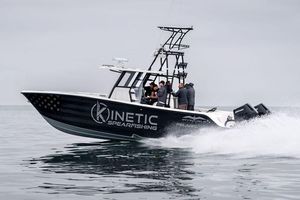 Invincible 33 Catamaran 2024 Invincible 33 Catamaran speeding on water, featuring "Kinetic Spearfishing" branding.
