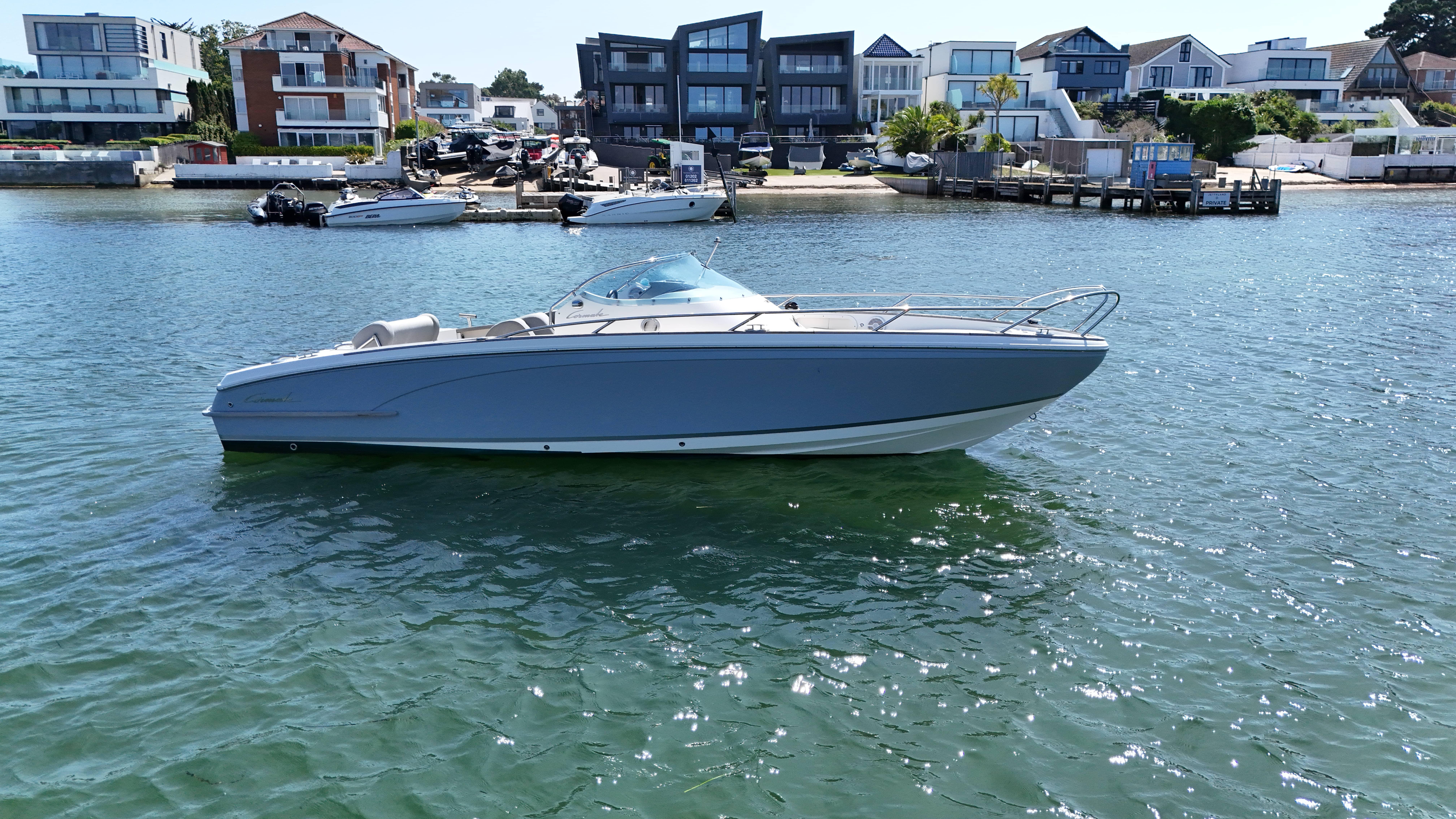 Cormate T24 Supermarine 2017 Cormate T24 Supermarine boat on water near modern waterfront homes.