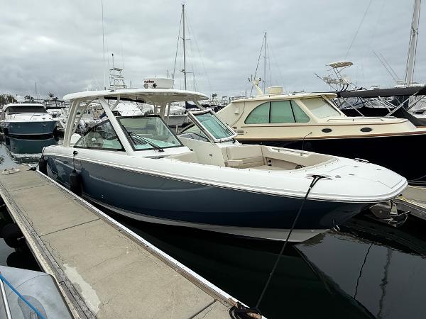 Boston Whaler 320 Vantage 2019 Boston Whaler 320 Vantage boat docked at marina, overcast sky.