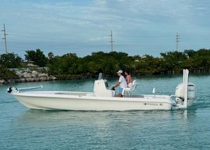 Contender 26 Bay 2025 Contender 26 Bay boat cruising on calm water with two passengers.