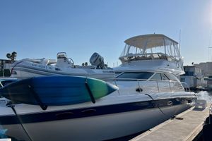 Sea Ray 400 Sedan Bridge 2000 Sea Ray 400 Sedan Bridge yacht docked with kayak and inflatable boat.