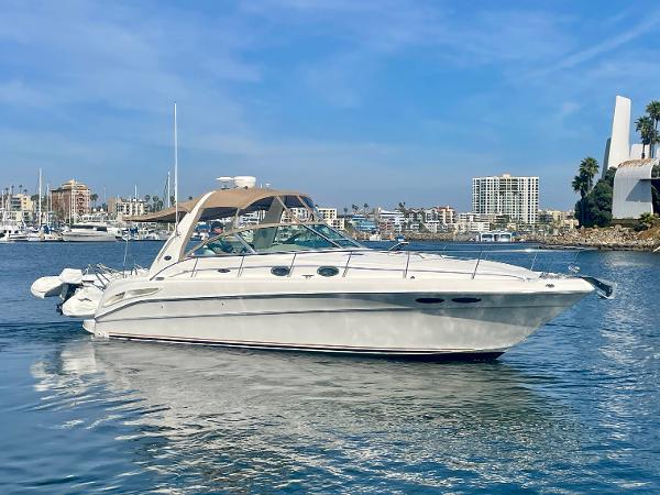 Sea Ray 340 Sundancer 2001 Sea Ray 340 Sundancer yacht on calm water, cityscape background.