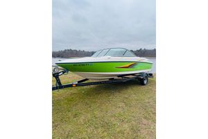 Maxum 1800 MX 2008 Maxum 1800 MX boat in vibrant green on trailer by a lake.