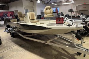 Xpress H20B Bay 2025 Xpress H20B Bay boat on display in showroom with trailer.