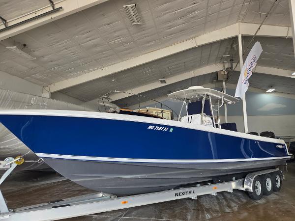 Contender 33 Tournament 2008 Contender 33 Tournament boat in blue, displayed indoors on a trailer.