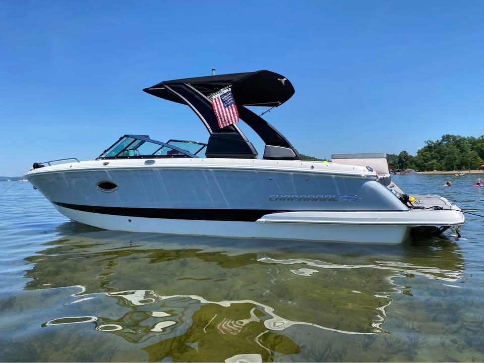 Chaparral 257 SSX 2019 Chaparral 257 SSX boat on clear water, sunny day, American flag displayed.