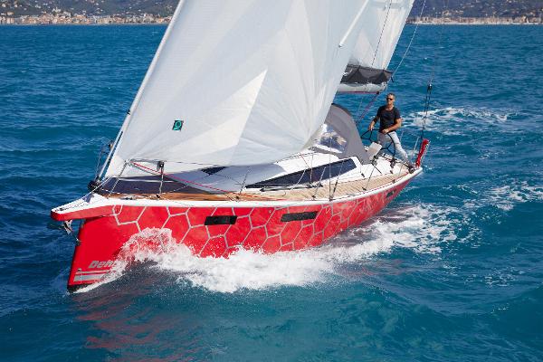 Dehler 38 SQ 2025 Dehler 38 SQ sailboat with red hull sailing on blue ocean.