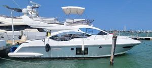 Azimut 45 Flybridge 2013 Azimut 45 Flybridge yacht docked in marina, clear blue sky.