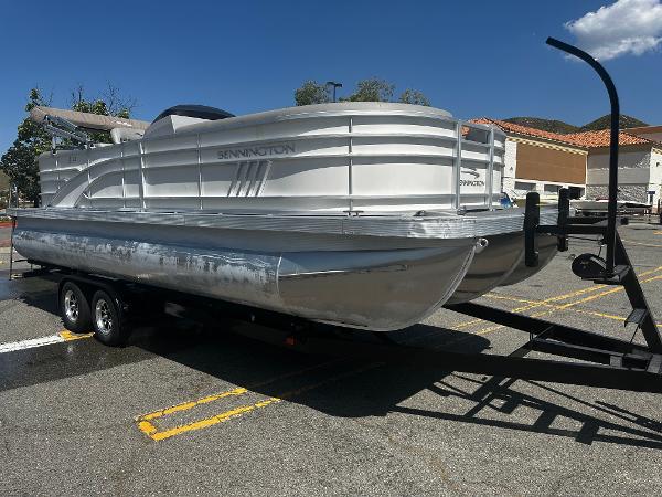 Bennington 23 LSR 2021 Bennington 23 LSR pontoon boat on a trailer in a parking lot.