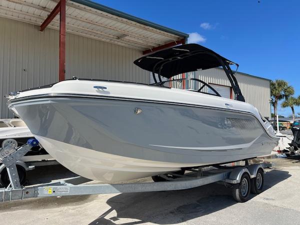 Bayliner D22 2025 Bayliner D22 boat on trailer, parked outdoors under a clear blue sky.