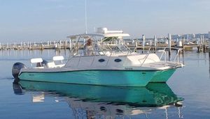 Twin Vee 29 Express 2011 Twin Vee 29 Express boat on calm water near docks.