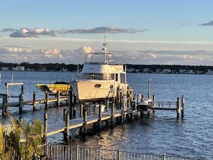Beneteau Swift Trawler 44 2019 Beneteau Swift Trawler 44 docked on a serene waterfront.