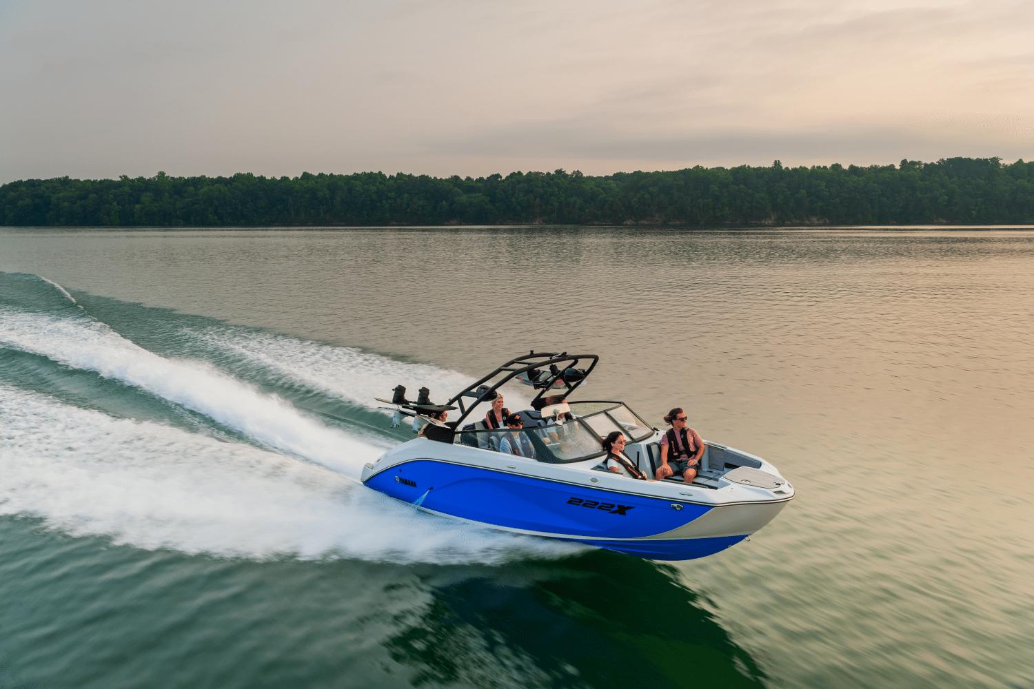 Yamaha Boats 222XD 2024 Yamaha Boats 222XD speeding on a lake with passengers.